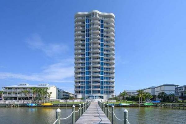 condo rental tower along the water with boardwalk leading right to the complex in alabama gulf coast beach town
