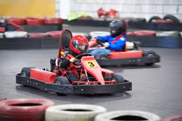 kids at a go kart park on a course