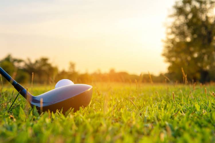 close up of golf club on tee at a course 